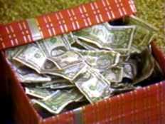 Box of money representing end of year savings.